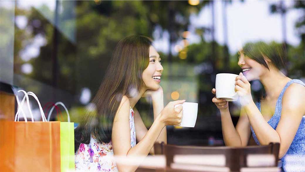 2 women drinking coffee and chatting