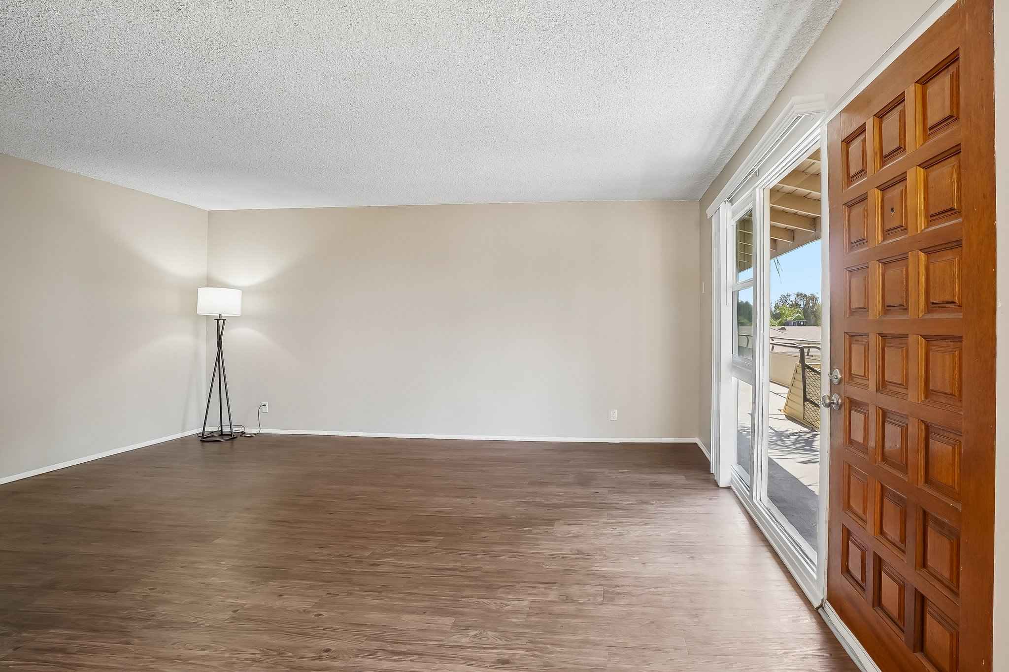 living room wood floors floor lamp at Terraces