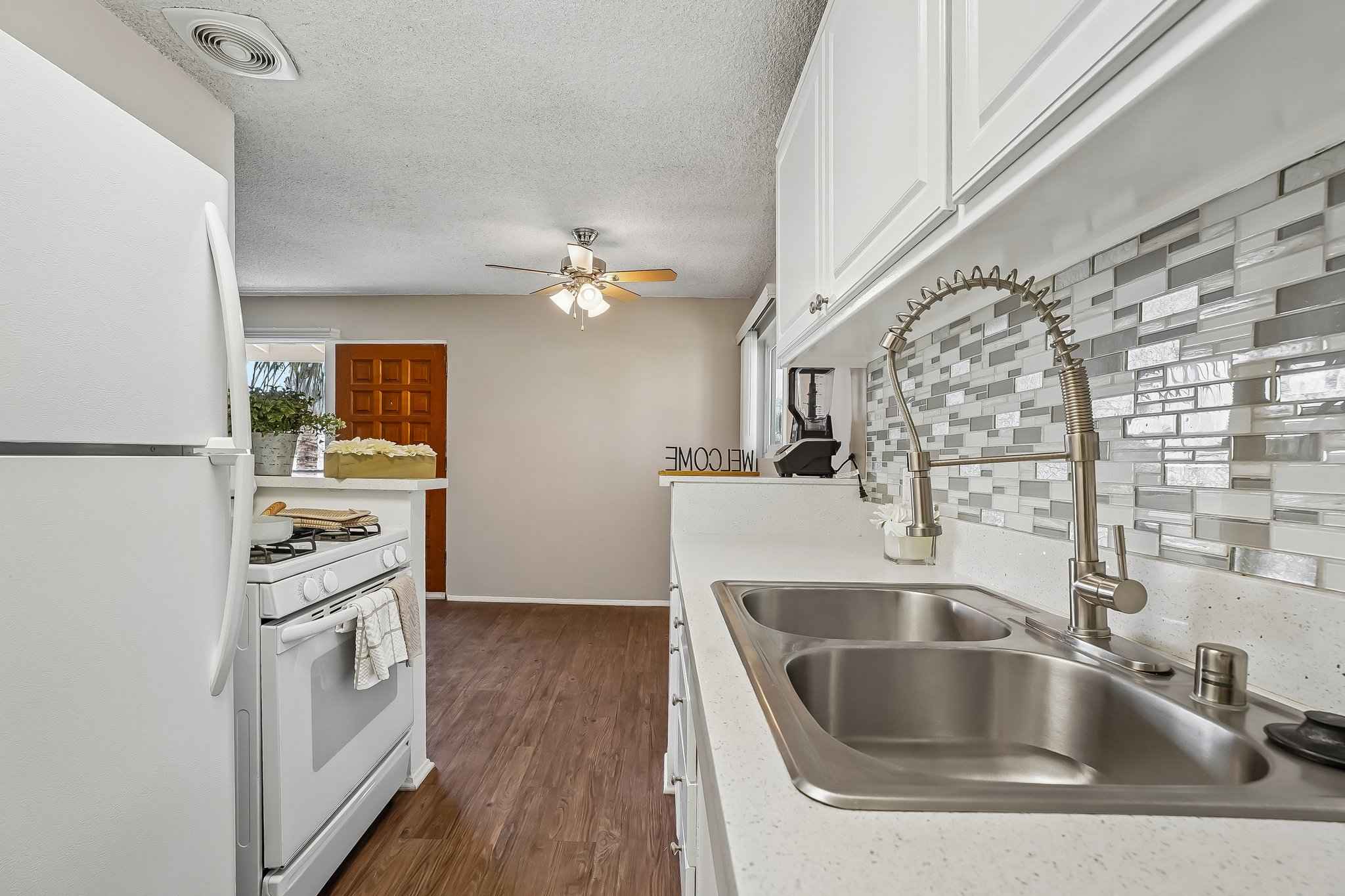 galley kitchen gas range dining view at Terraces