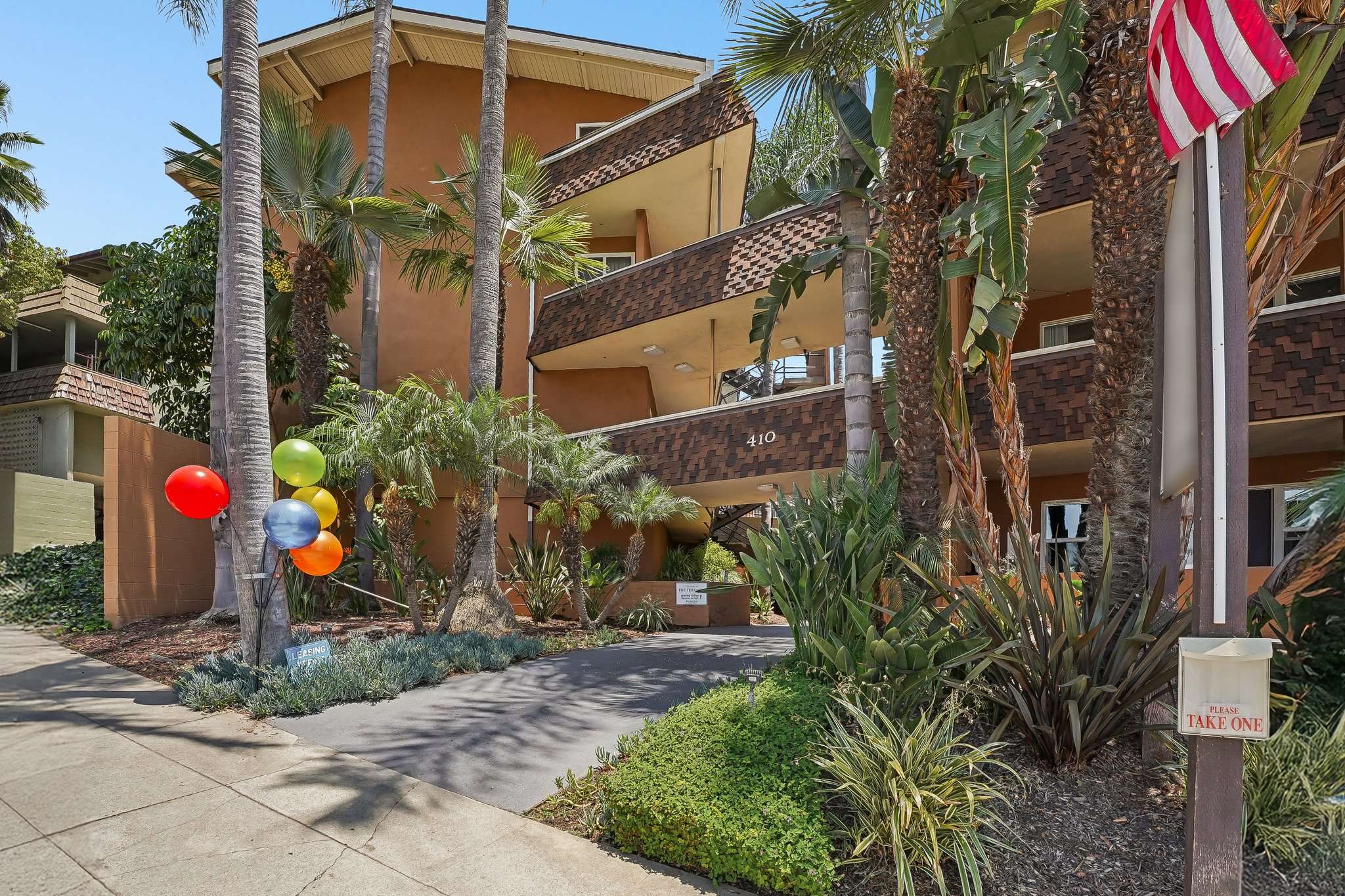 Terraces at South Pasadena building entrance and leasing office with palm trees